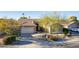 Single-story home with a two-car garage and desert landscaping at 9754 E Natal Ave, Mesa, AZ 85209