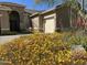 Landscaped front yard with colorful flowers and stone accents at 9754 E Natal Ave, Mesa, AZ 85209