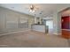 Gathering room with hardwood and carpeted floors, and a kitchen view at 9754 E Natal Ave, Mesa, AZ 85209