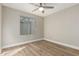 Spacious bedroom with hardwood floors and a window offering natural light at 10896 E Sahuaro Dr, Scottsdale, AZ 85259