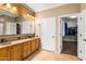 Double vanity bathroom with granite countertops and large mirror at 10902 E Silver Mine Rd, Gold Canyon, AZ 85118