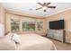Bright bedroom featuring a large TV and comfortable bed at 10902 E Silver Mine Rd, Gold Canyon, AZ 85118