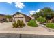 Single-story home with desert landscaping and two-car garage at 10902 E Silver Mine Rd, Gold Canyon, AZ 85118