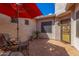 Covered patio with seating area, umbrella, and tile flooring at 10902 E Silver Mine Rd, Gold Canyon, AZ 85118