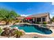 Lush backyard oasis with a pool and spa at 10902 E Silver Mine Rd, Gold Canyon, AZ 85118