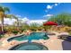 Resort-style pool with spa and red umbrella at 10902 E Silver Mine Rd, Gold Canyon, AZ 85118