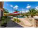 Inviting pool with waterfall feature and red umbrella at 10902 E Silver Mine Rd, Gold Canyon, AZ 85118