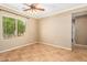 Bright spare bedroom with tile floors and ceiling fan at 10902 E Silver Mine Rd, Gold Canyon, AZ 85118