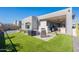 Outdoor patio with seating area, fire pit, and artificial turf at 12387 E Black Rock Rd, Scottsdale, AZ 85255
