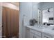 Clean bathroom with a white vanity and a beige shower curtain at 12387 E Black Rock Rd, Scottsdale, AZ 85255
