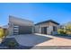 Modern home exterior with two-car garage and desert landscaping at 12387 E Black Rock Rd, Scottsdale, AZ 85255