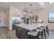 Modern kitchen with large island, stainless steel appliances, and white cabinets at 12387 E Black Rock Rd, Scottsdale, AZ 85255