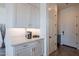 Kitchenette with white cabinets and quartz countertops at 12387 E Black Rock Rd, Scottsdale, AZ 85255