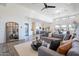 Spacious living room with a gray sectional sofa, a geometric coffee table, and large windows at 12387 E Black Rock Rd, Scottsdale, AZ 85255