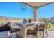 Outdoor kitchen with stone countertops and seating at 12387 E Black Rock Rd, Scottsdale, AZ 85255