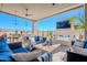 Outdoor patio with seating, fireplace, and TV at 12387 E Black Rock Rd, Scottsdale, AZ 85255