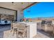 Covered patio with comfortable seating and kitchen at 12387 E Black Rock Rd, Scottsdale, AZ 85255