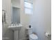 Small powder room with pedestal sink and toilet at 12387 E Black Rock Rd, Scottsdale, AZ 85255