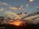 Stunning sunrise view showcasing the sun's rays through a partly cloudy sky over the desert landscape at 12387 E Black Rock Rd, Scottsdale, AZ 85255