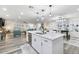 Modern kitchen with white cabinets, a large island, and stainless steel appliances at 12938 W Seville Dr, Sun City West, AZ 85375