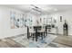 Bright dining room with modern light fixture and seating for four at 12938 W Seville Dr, Sun City West, AZ 85375