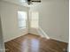 Bedroom with wood-look flooring, a ceiling fan, and two windows at 1314 E Helena Dr, Phoenix, AZ 85022