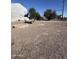 Large gravel lot with a trailer and partial view of street at 140 W 8Th Ave, Mesa, AZ 85210