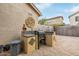 Outdoor kitchen with grill and stone countertops at 14595 W Acapulco Ln, Surprise, AZ 85379