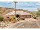 House exterior with three-car garage and desert landscaping at 15414 E Westridge Dr, Fountain Hills, AZ 85268