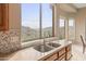 Kitchen features a double sink, granite countertops, and mountain views at 15414 E Westridge Dr, Fountain Hills, AZ 85268