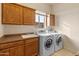 Laundry room features washer, dryer, and cabinets at 15414 E Westridge Dr, Fountain Hills, AZ 85268