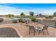 Relaxing backyard oasis with golf course views and seating area at 16155 W Sentinel Dr, Sun City West, AZ 85375