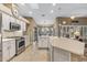 Modern kitchen with white cabinets, stainless steel appliances, and large island at 16155 W Sentinel Dr, Sun City West, AZ 85375