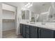 Elegant bathroom with double vanity, walk-in shower, and large closet at 17937 W Cedarwood Ln, Goodyear, AZ 85338