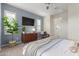 Main bedroom with large TV, dresser, and plenty of natural light at 17937 W Cedarwood Ln, Goodyear, AZ 85338