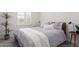 Cozy bedroom with a queen-size bed and window with plantation shutters at 17937 W Cedarwood Ln, Goodyear, AZ 85338