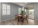 Bright dining area with round wooden table and four chairs, near sliding door at 17937 W Cedarwood Ln, Goodyear, AZ 85338