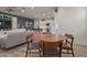 Modern dining area with a round table and chairs, near kitchen and living room at 17937 W Cedarwood Ln, Goodyear, AZ 85338