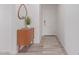 Bright entryway with mid-century modern console table and mirror at 17937 W Cedarwood Ln, Goodyear, AZ 85338