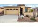 Single-story home with two-car garage and desert landscaping at 17937 W Cedarwood Ln, Goodyear, AZ 85338