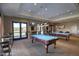 Game room with two pool tables, comfortable seating, and views to the outside at 17937 W Cedarwood Ln, Goodyear, AZ 85338