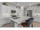 Modern kitchen with white cabinets, stainless steel appliances, and a large island at 17937 W Cedarwood Ln, Goodyear, AZ 85338