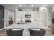 Modern kitchen with white cabinets, quartz countertops, and island seating at 17937 W Cedarwood Ln, Goodyear, AZ 85338