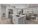 Open concept kitchen and living area with island and gray furniture at 17937 W Cedarwood Ln, Goodyear, AZ 85338