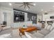 Open living space with built-in shelving, a large TV, and comfortable seating at 17937 W Cedarwood Ln, Goodyear, AZ 85338