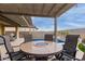 Outdoor patio with fire pit table and seating area at 17937 W Cedarwood Ln, Goodyear, AZ 85338