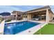 Inviting backyard pool with a covered patio and putting green at 17937 W Cedarwood Ln, Goodyear, AZ 85338