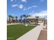 Community playground with artificial turf and shaded seating at 18245 W Papago St, Goodyear, AZ 85338