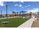 Community playground with artificial turf and cornhole at 18245 W Papago St, Goodyear, AZ 85338