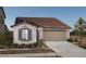 Charming single-story home showcasing desert landscaping, a tile roof, and a two-car garage at 18251 W Papago St, Goodyear, AZ 85338